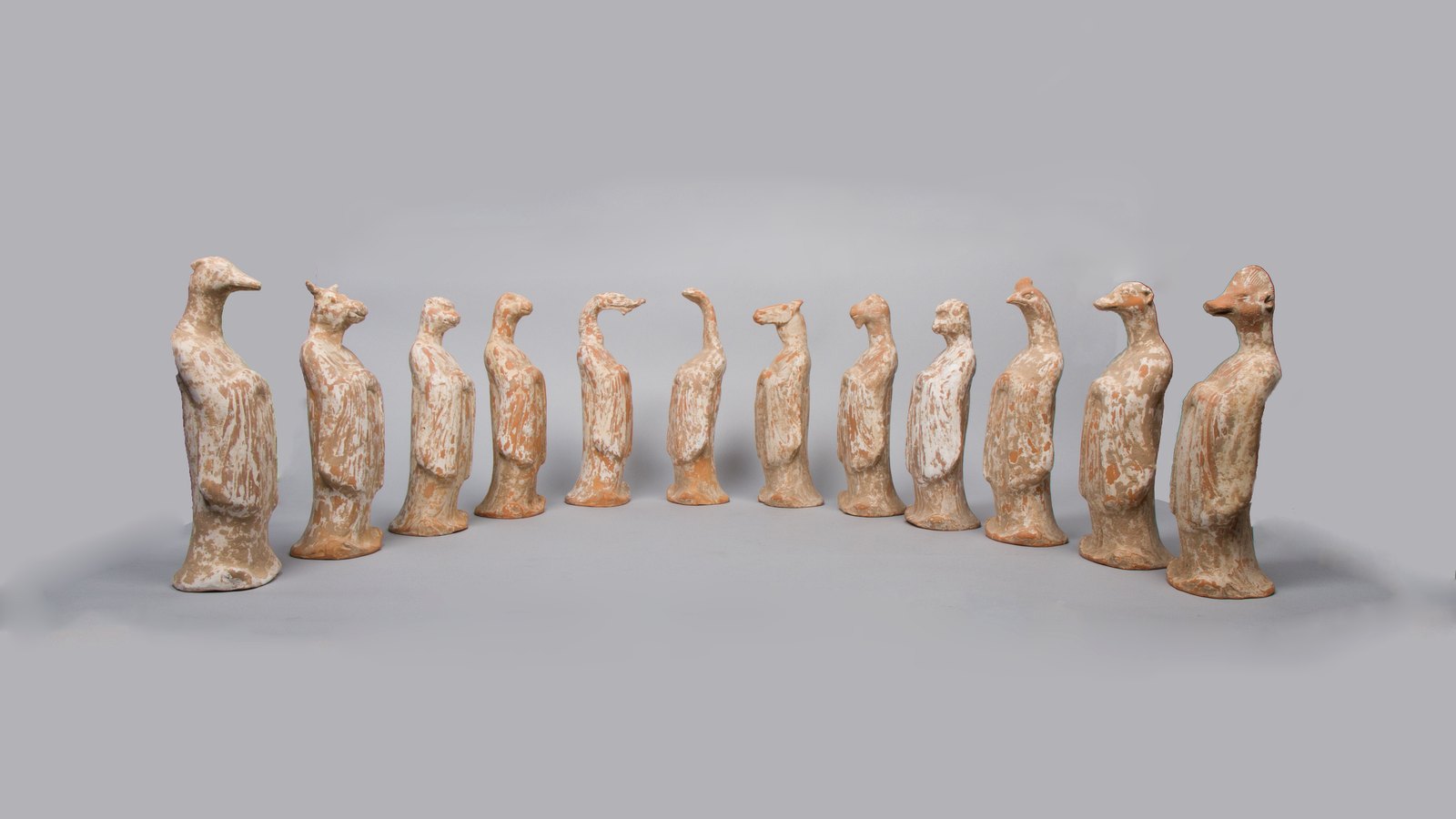 Doce figuras de cerámica alineadas, cada una con cabeza de animal y cuerpo humano. Una fecha de nacimiento fija en qué casilla del ciclo cae un año; qué animal lleva esa casilla depende de la línea desde la que se cuente el año.